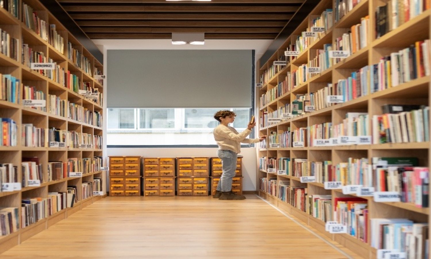 young-student-looking-book-library